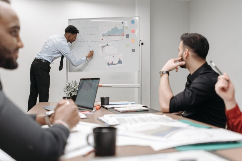 Colleagues in a business meeting discussing data and strategies at the office.